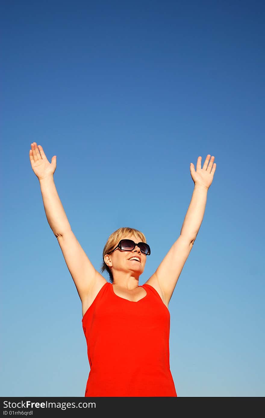 Happy woman cheering outside on a sunny day