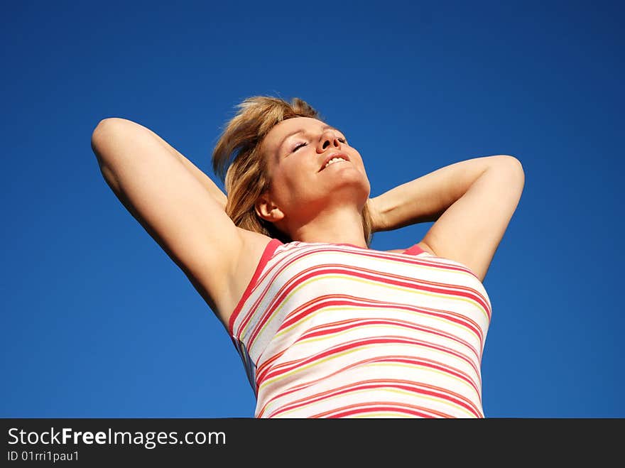 Woman relaxing ourdoors in the sun. Woman relaxing ourdoors in the sun