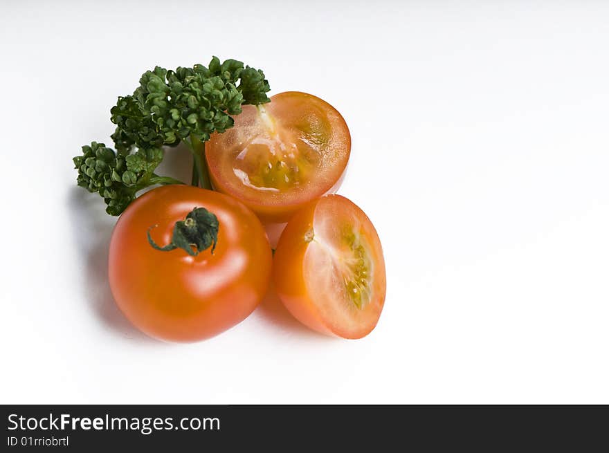 Cherry tomato and parsley on white background