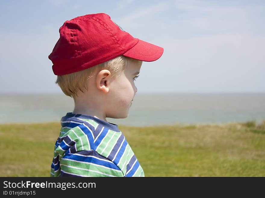 A young 2 year old toddler gazing out to sea. A young 2 year old toddler gazing out to sea