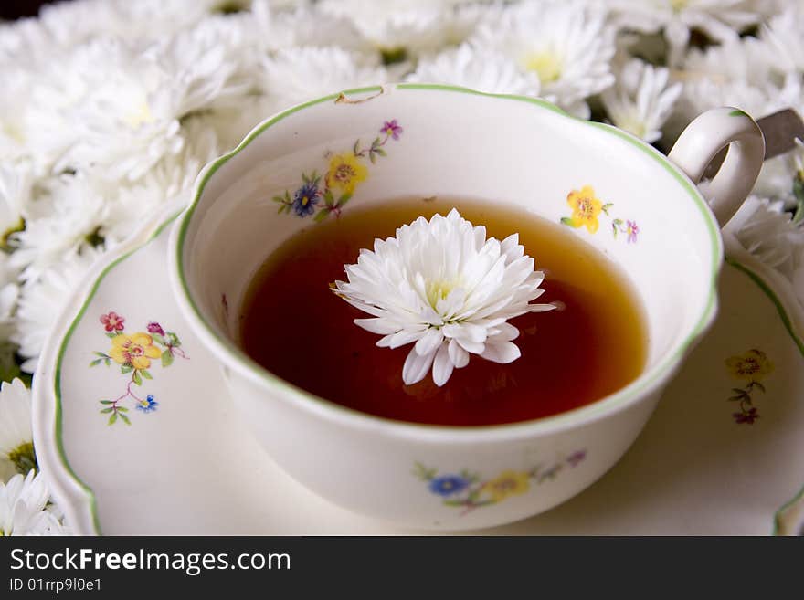 Cup of tea in flowers surrounding