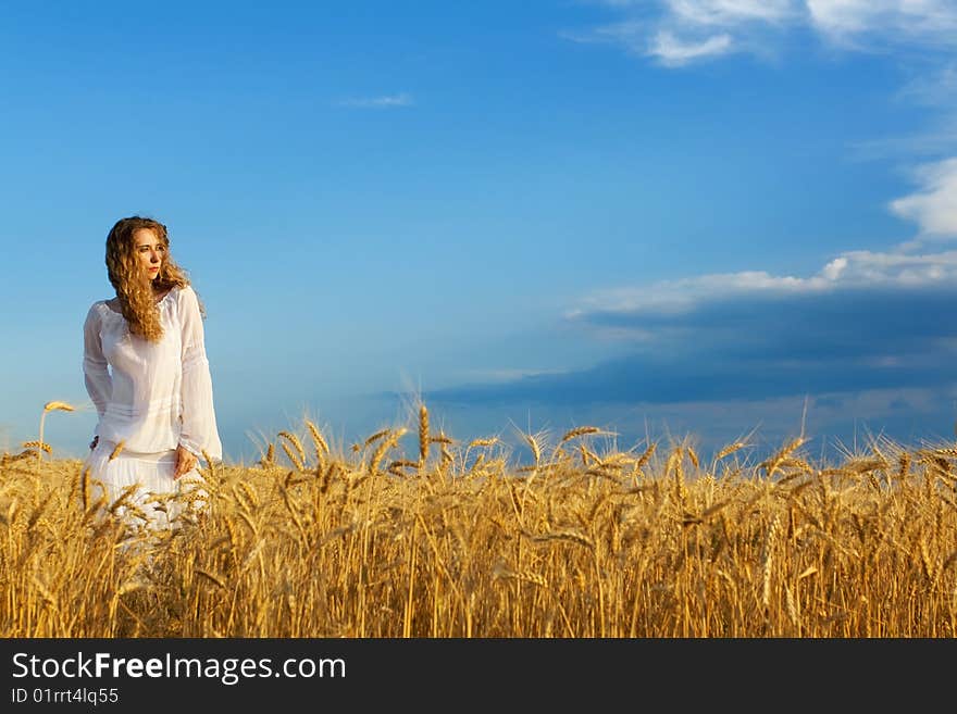 Woman in wheat field at sunset. Woman in wheat field at sunset