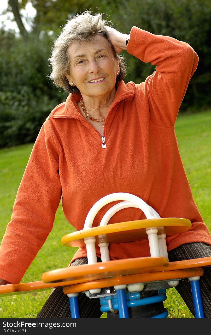 Happy senior woman on a playground. Happy senior woman on a playground