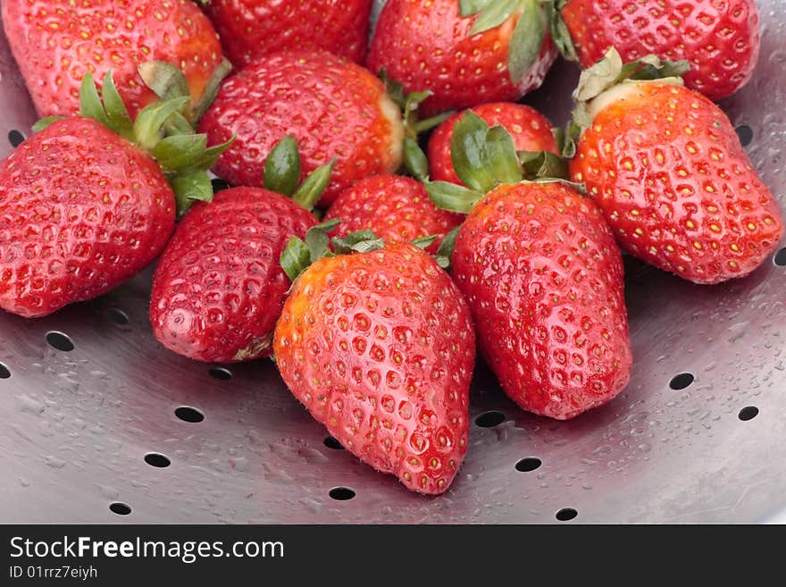 Fresh strawberries in steel colander