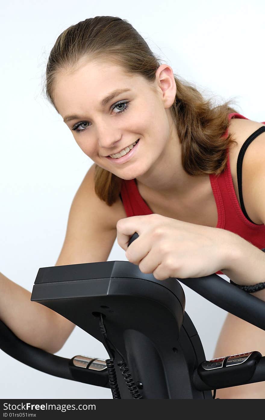 Young sporty woman on a ergometer