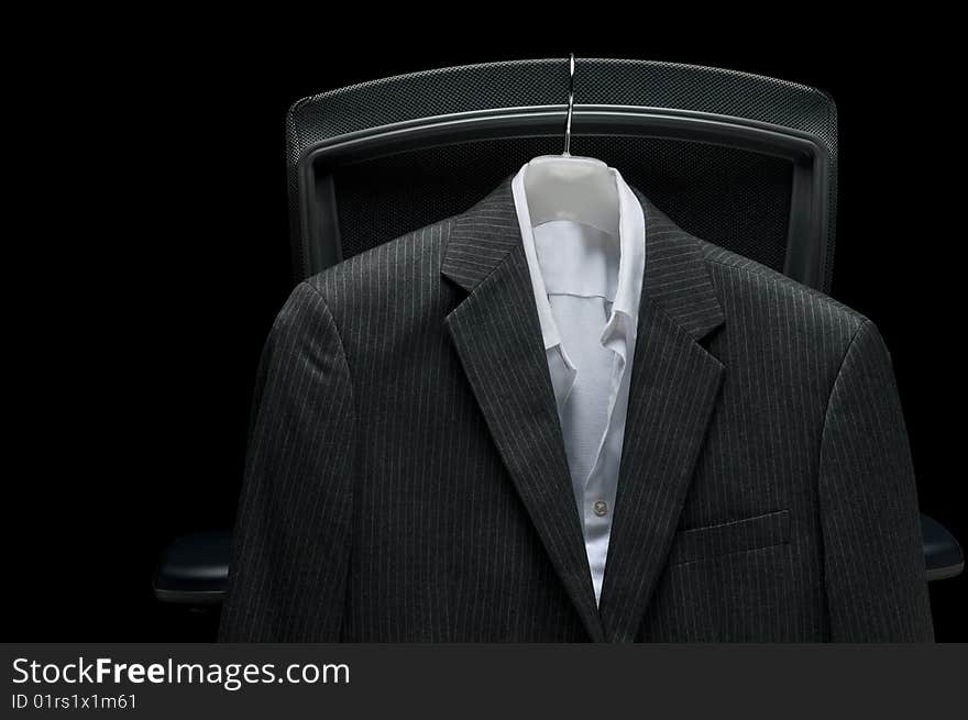 Business jacket and white shirt hanging on the back of an office chair. Business jacket and white shirt hanging on the back of an office chair