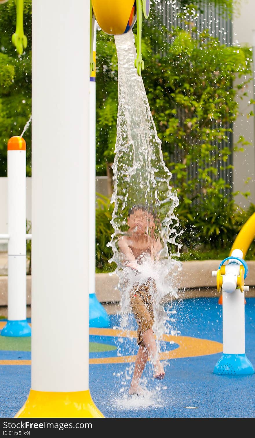 Boy trying to intercept the water pouring from a bucket at random intervals. Boy trying to intercept the water pouring from a bucket at random intervals