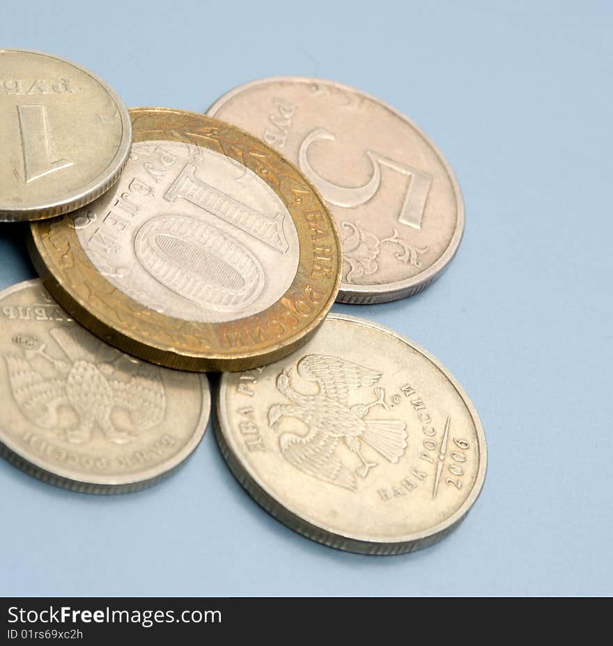 Coins on colored (blue) background. Close-up. Coins of Russian Federation bank. Coins on colored (blue) background. Close-up. Coins of Russian Federation bank