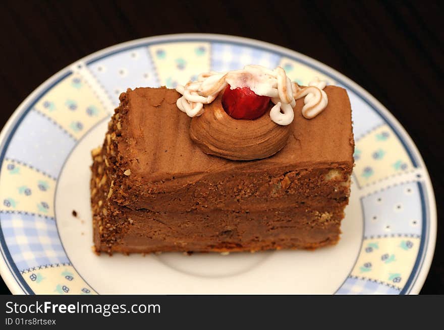 A slice of chocolate cake on a plate ready to eat