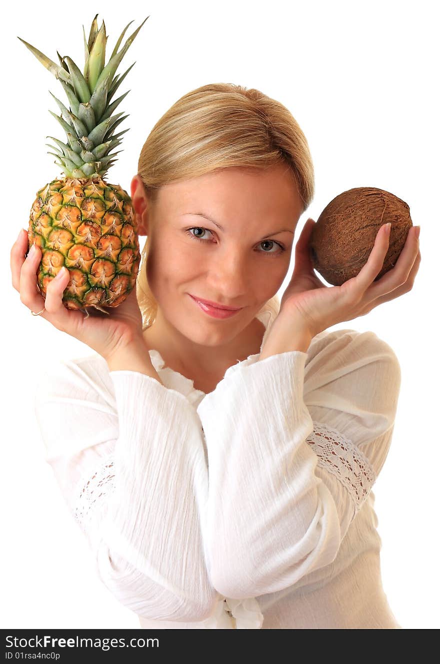 A beautiful girl holds a pineapple and coconut. A beautiful girl holds a pineapple and coconut.