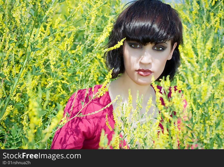 The portrait of girl in the environment of yellow flowers. The portrait of girl in the environment of yellow flowers.