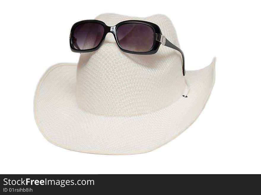 Hat and sunglasses on white background