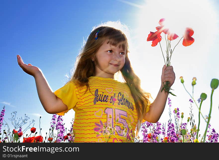 Little girl holding a bunch of sunny poppy