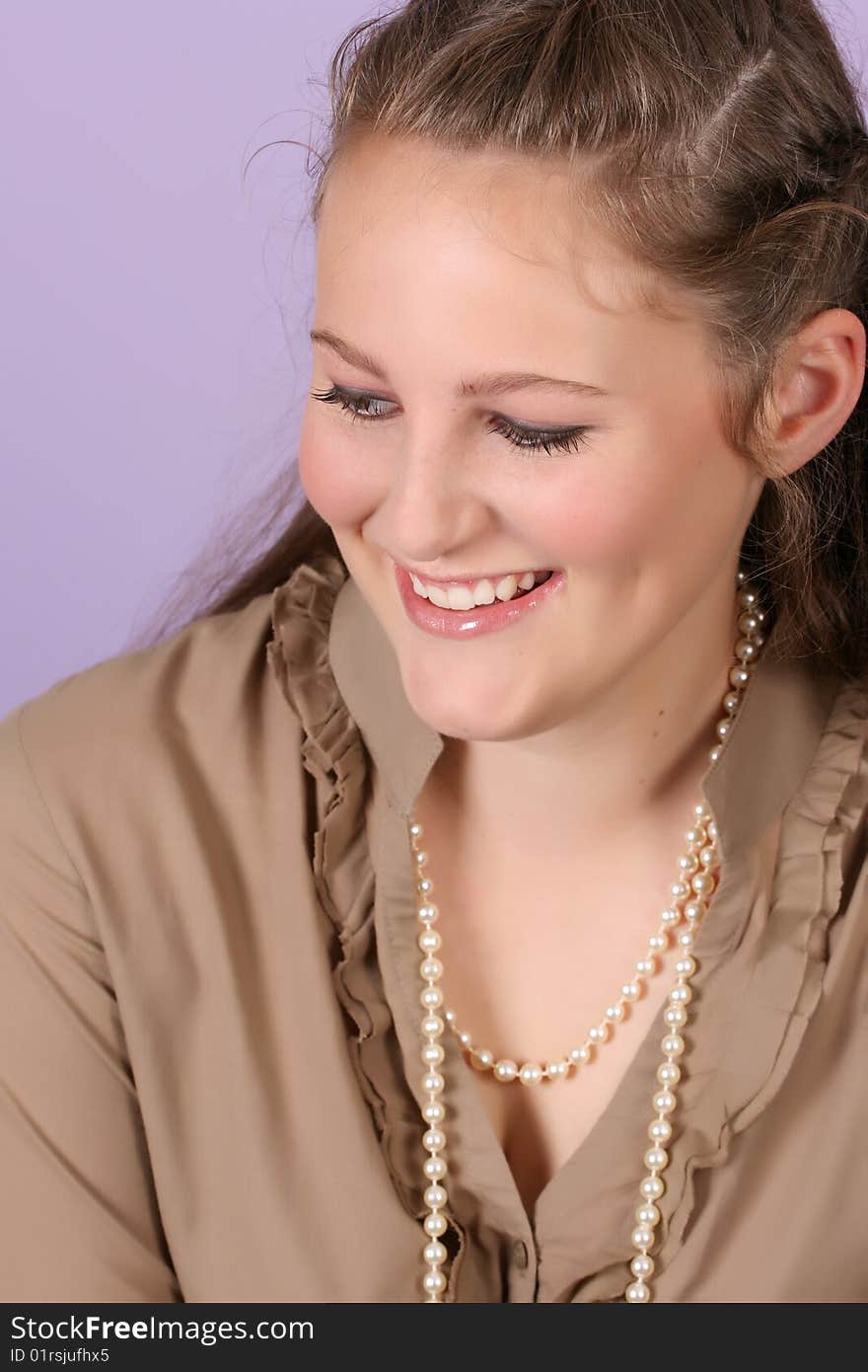 Beautiful teenage female against purple background, wearing pearls. Beautiful teenage female against purple background, wearing pearls