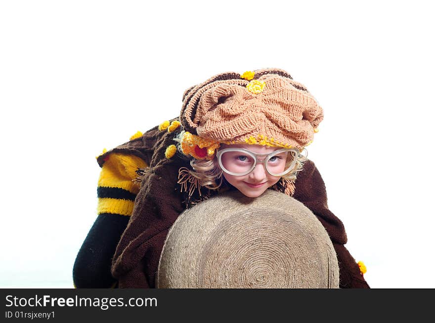 The girl in a knitted suit embraces the big ball with threads