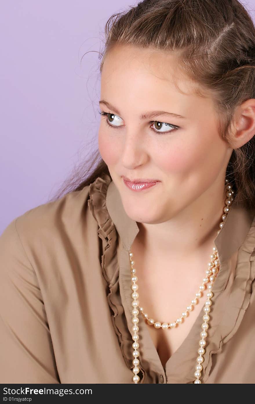 Beautiful teenage female against purple background, wearing pearls. Beautiful teenage female against purple background, wearing pearls