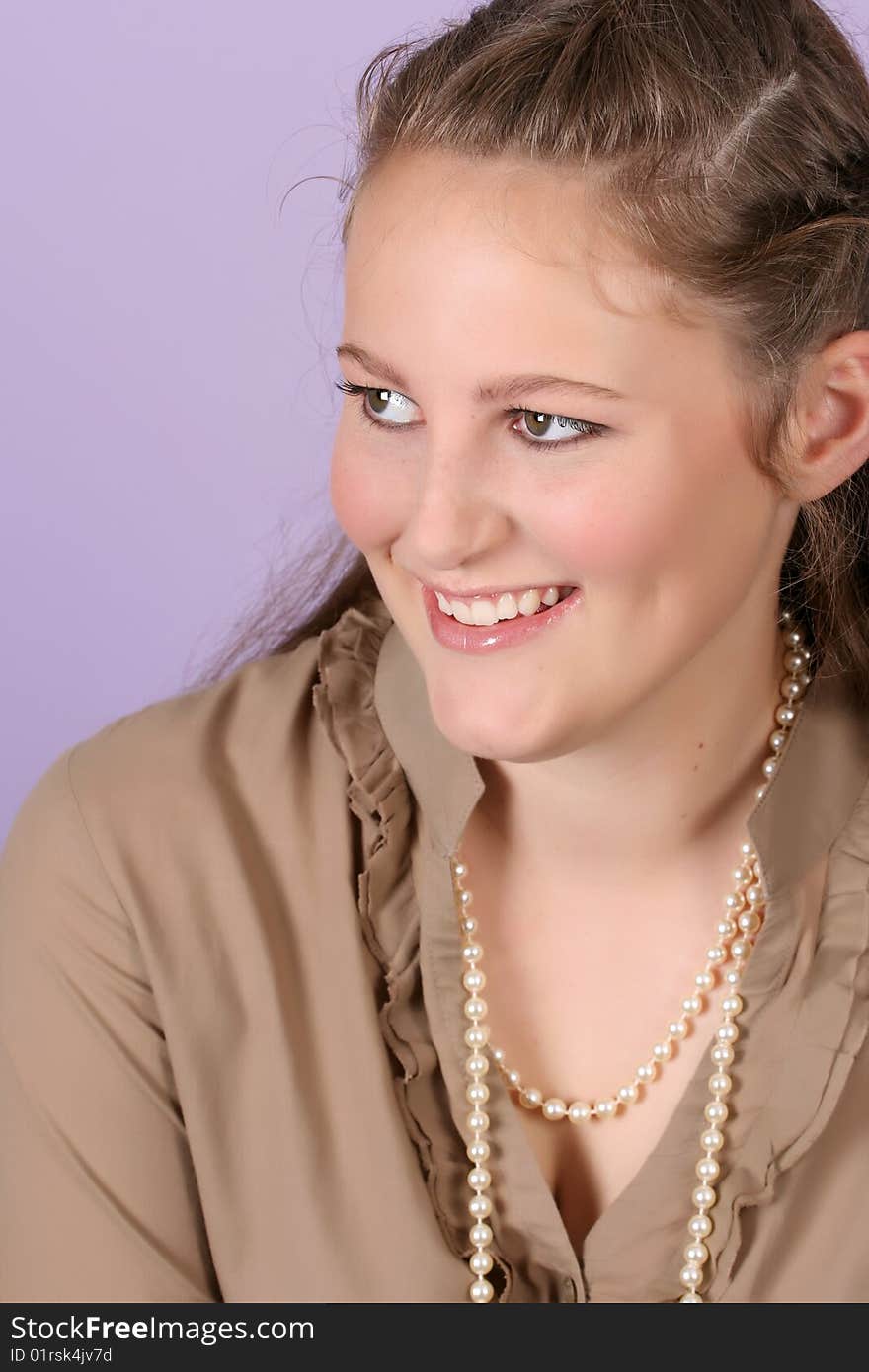 Beautiful teenage female against purple background, wearing pearls. Beautiful teenage female against purple background, wearing pearls