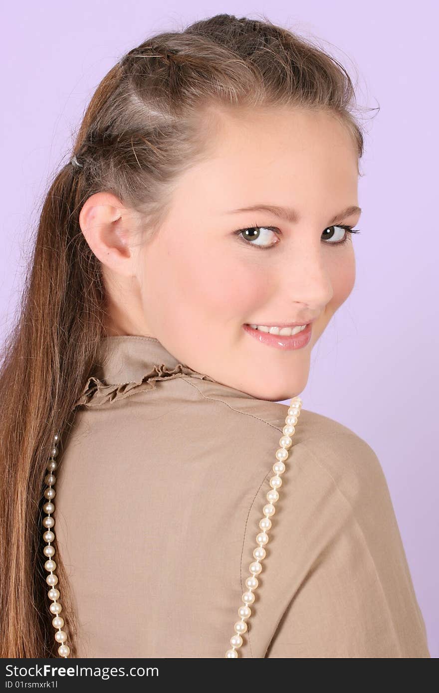 Beautiful teenage female against purple background, wearing pearls. Beautiful teenage female against purple background, wearing pearls