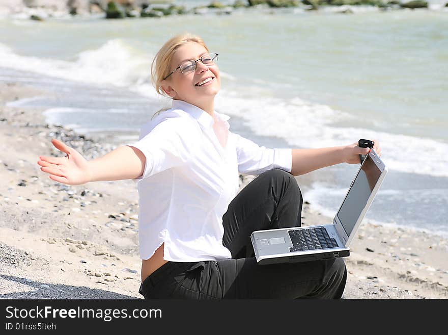 Businesswoman with business suit working on the beach. Businesswoman with business suit working on the beach