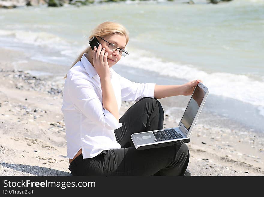 Businesswoman with business suit working on the beach. Businesswoman with business suit working on the beach