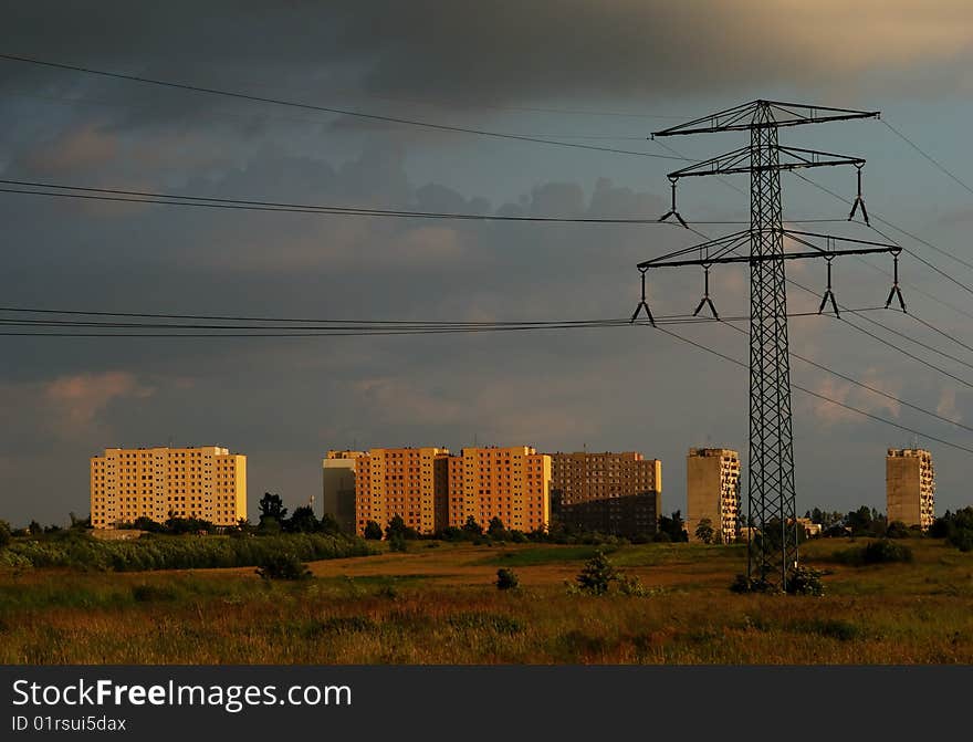 Power line and the city buildings at sunset. Power line and the city buildings at sunset