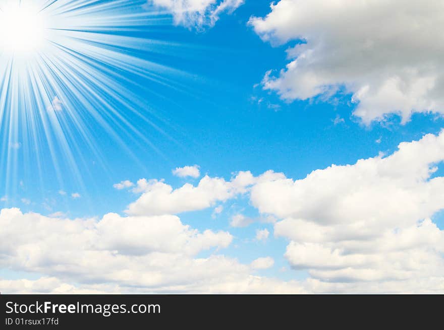 Blue sky is covered by white clouds and sun beams. Blue sky is covered by white clouds and sun beams.