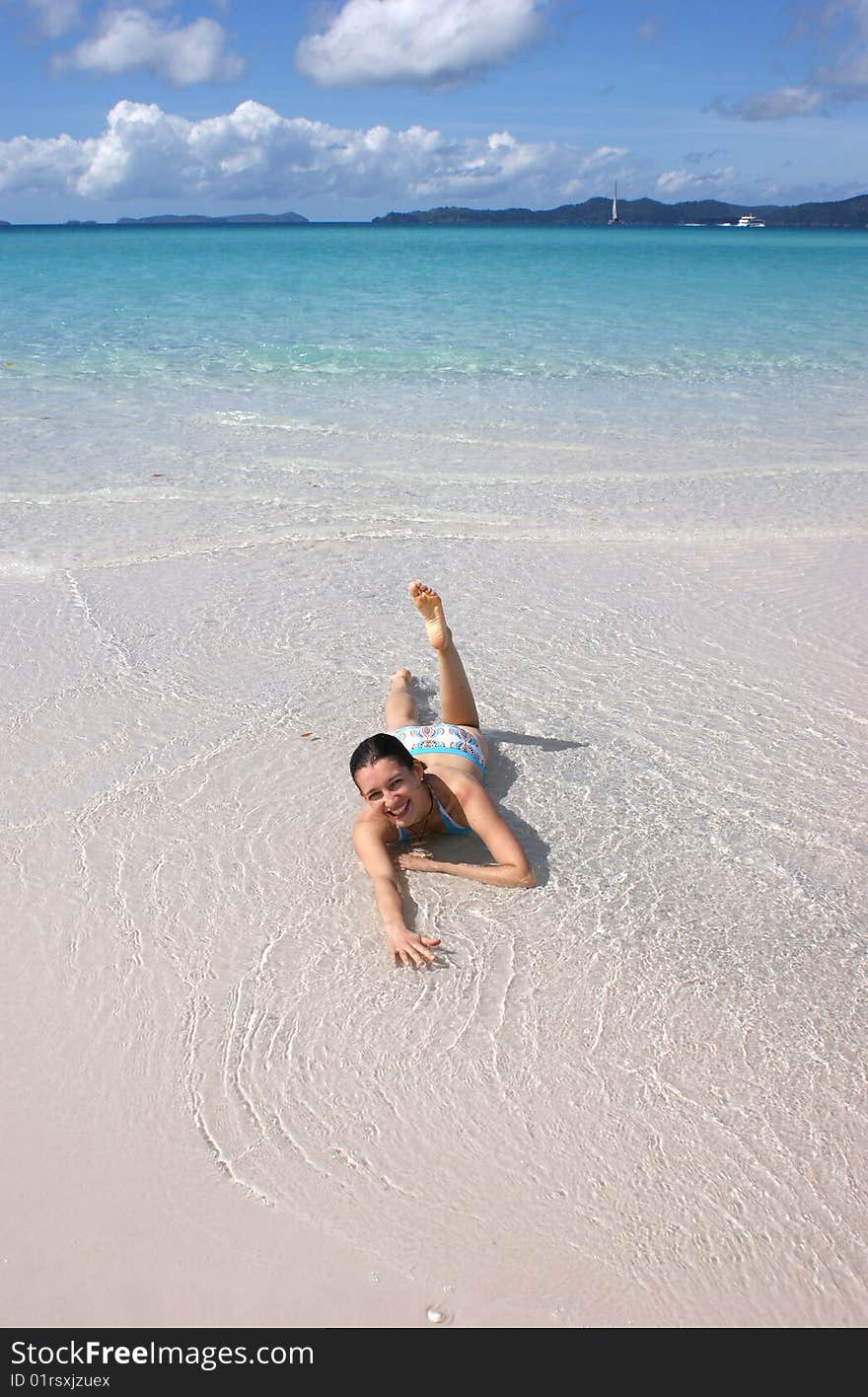 A girl enjoying the sun and water on Whitsundays island, Australia. A girl enjoying the sun and water on Whitsundays island, Australia.