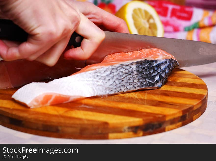 Fresh slice of salmon with lemon on the wood board