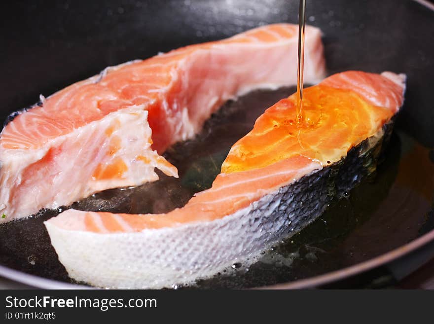 Fresh slice of salmon in the frying pan