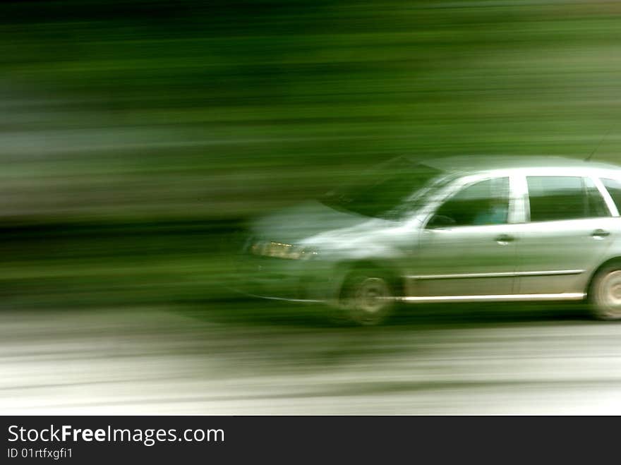 Speed car behind trees