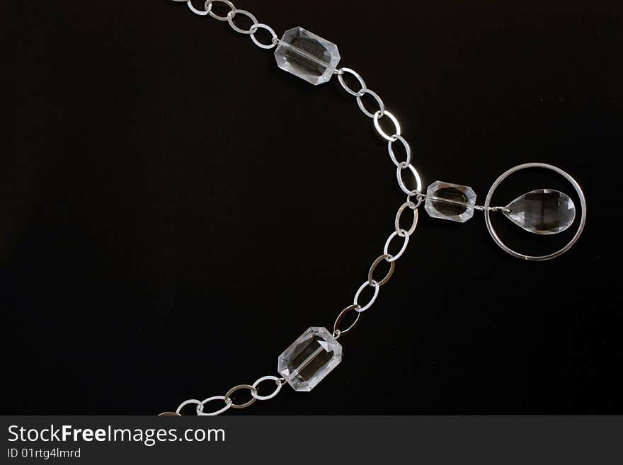 Costume jewellery of silvery color on black background