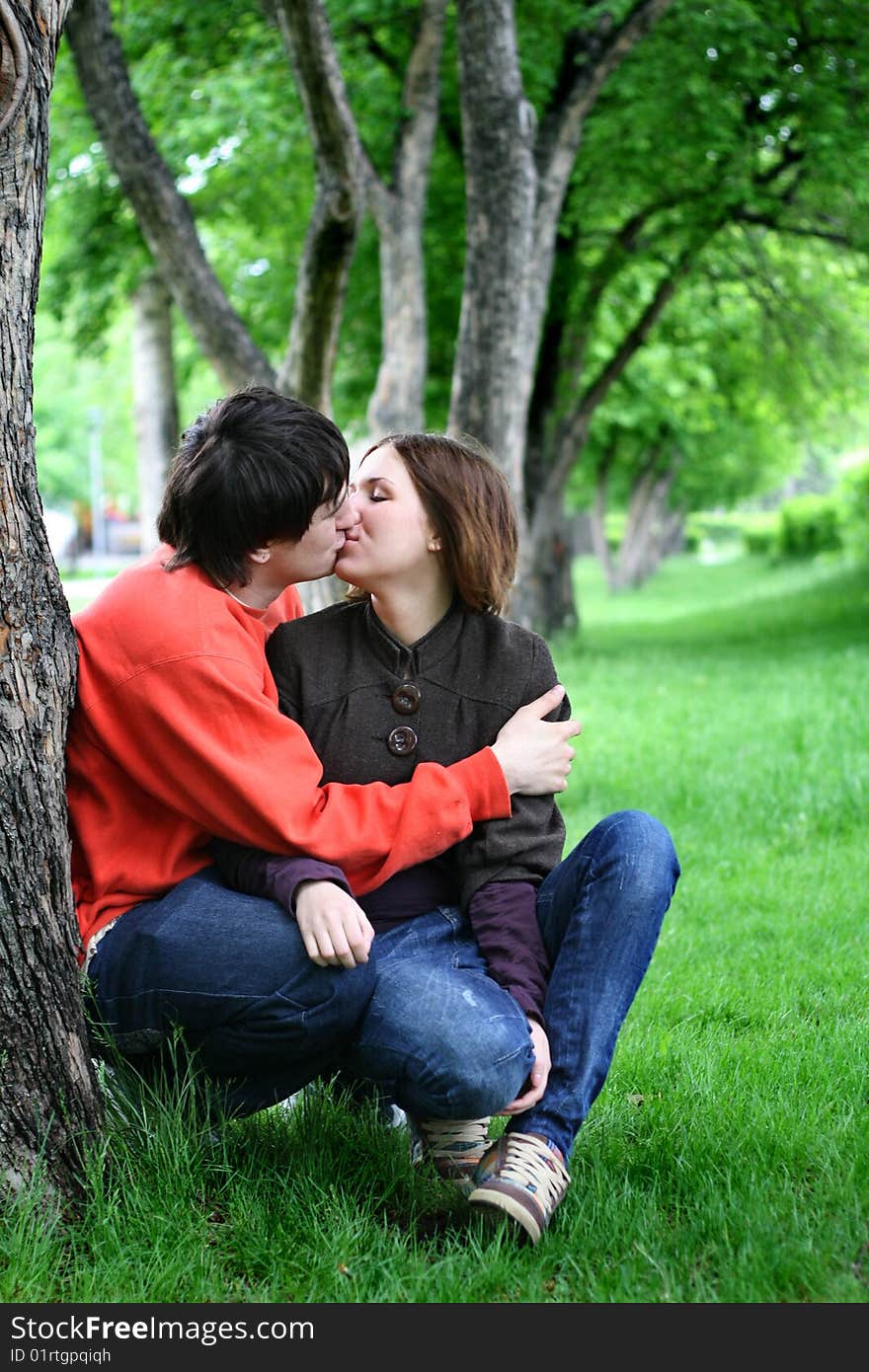 Couple kissing under a tree