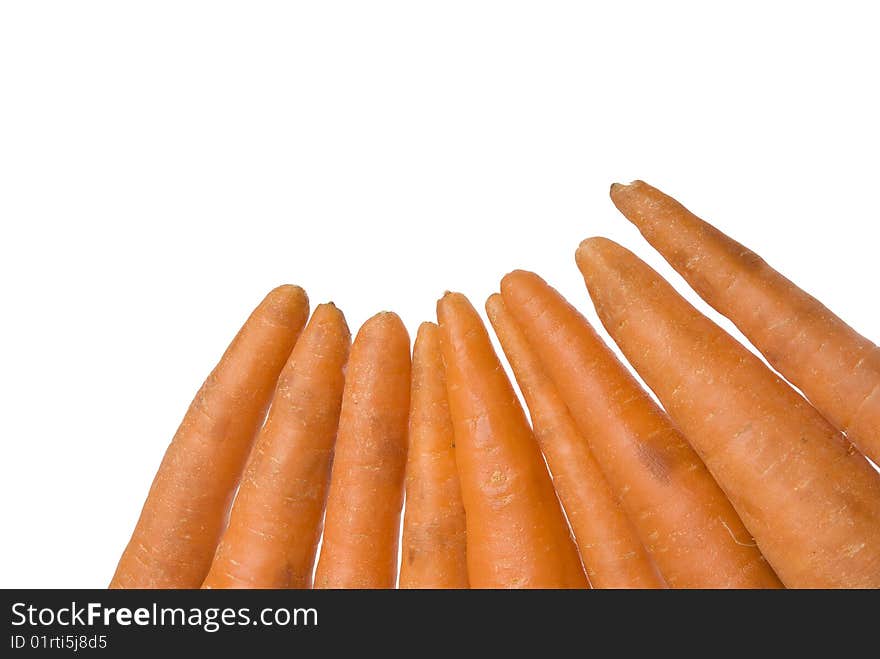 Ripe fresh carrots placed in the corner of the picture isolated on white background