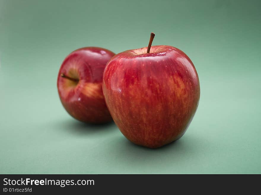 Two red apples on a gray background. Two red apples on a gray background