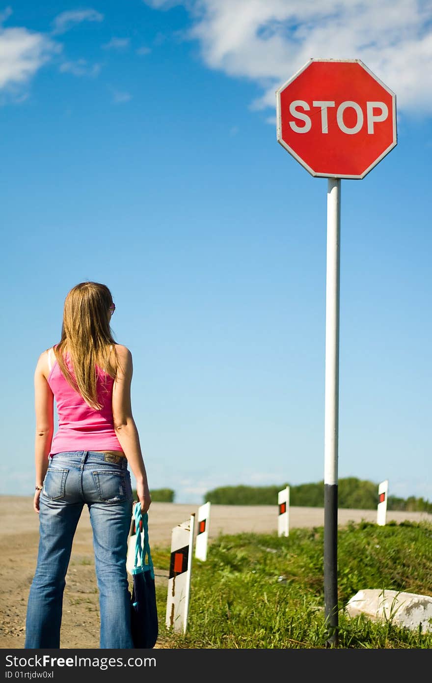 Young woman and stop sign