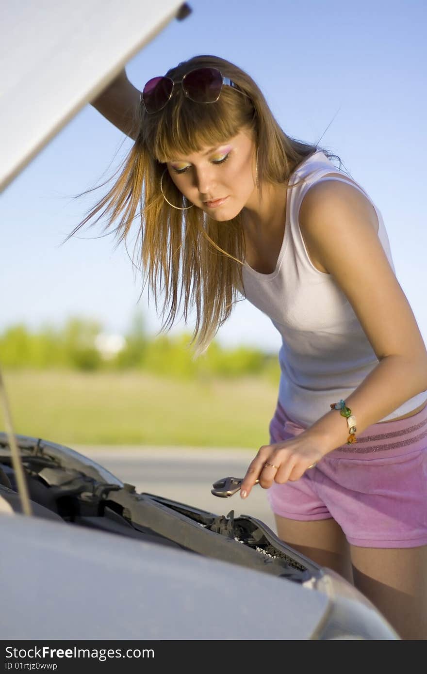 Girl looking under the car