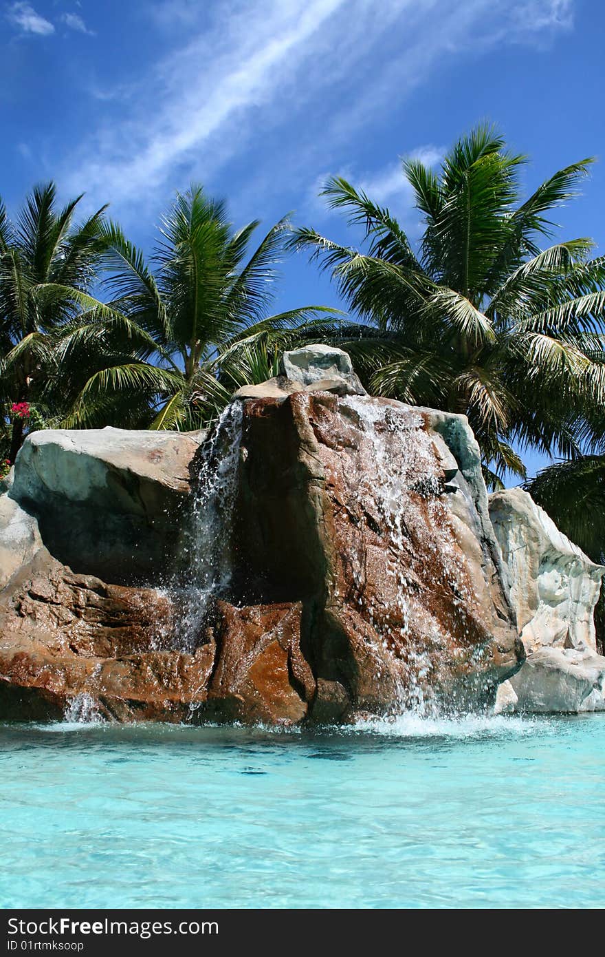 Tropical swimming pool and beautiful water with palms