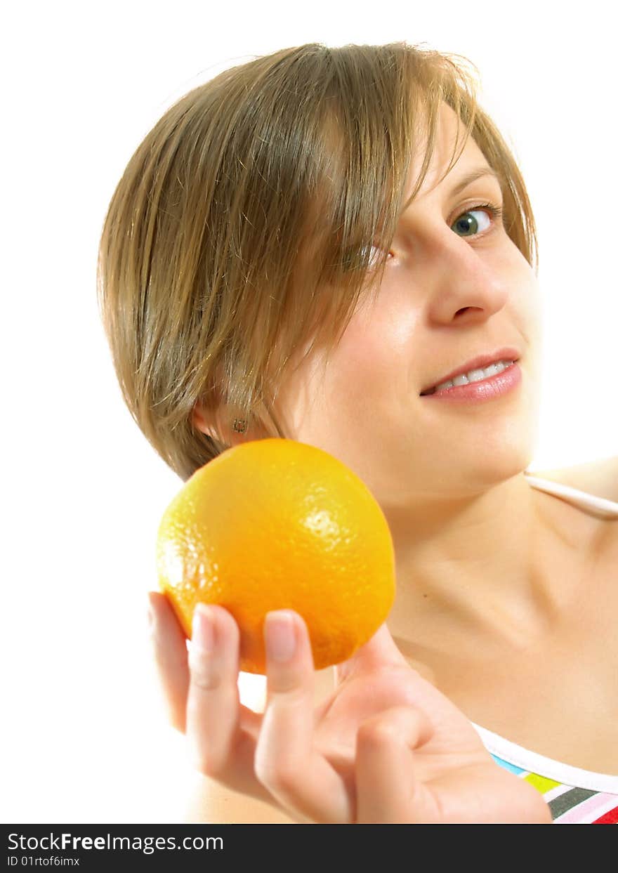 Portrait of a cute Caucasian blond girl with a nice colorful striped dress who is smiling and she is holding a fresh orange in her hand. Isolated on white. Portrait of a cute Caucasian blond girl with a nice colorful striped dress who is smiling and she is holding a fresh orange in her hand. Isolated on white.