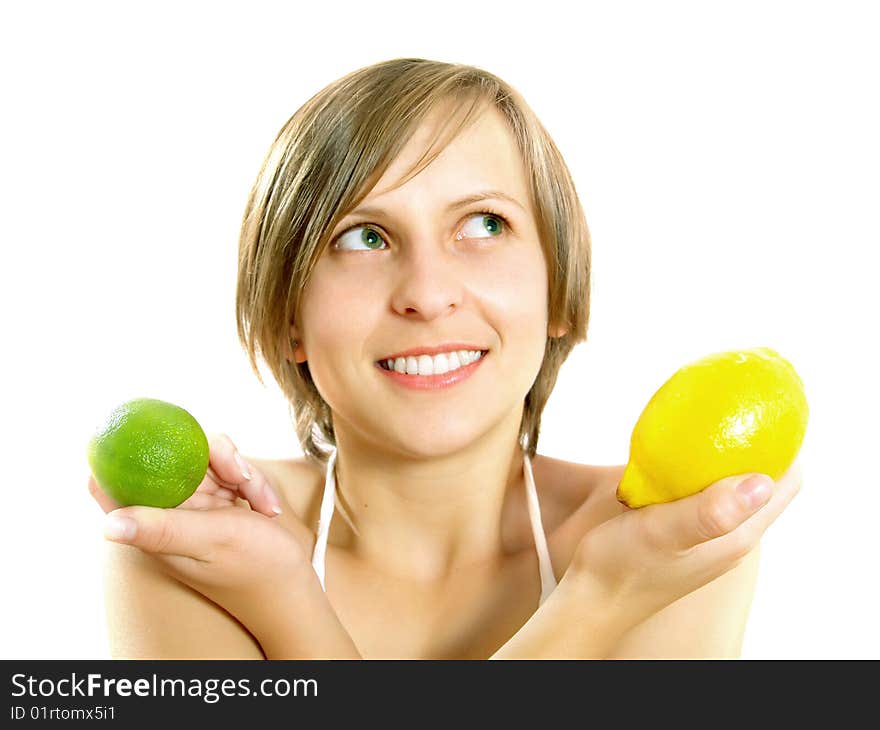 Portrait of a cute young Caucasian blond lady with a nice colorful striped summer dress who is smiling and she is holding a fresh lemon and a lime in her crossed hands. Isolated on white. Portrait of a cute young Caucasian blond lady with a nice colorful striped summer dress who is smiling and she is holding a fresh lemon and a lime in her crossed hands. Isolated on white.