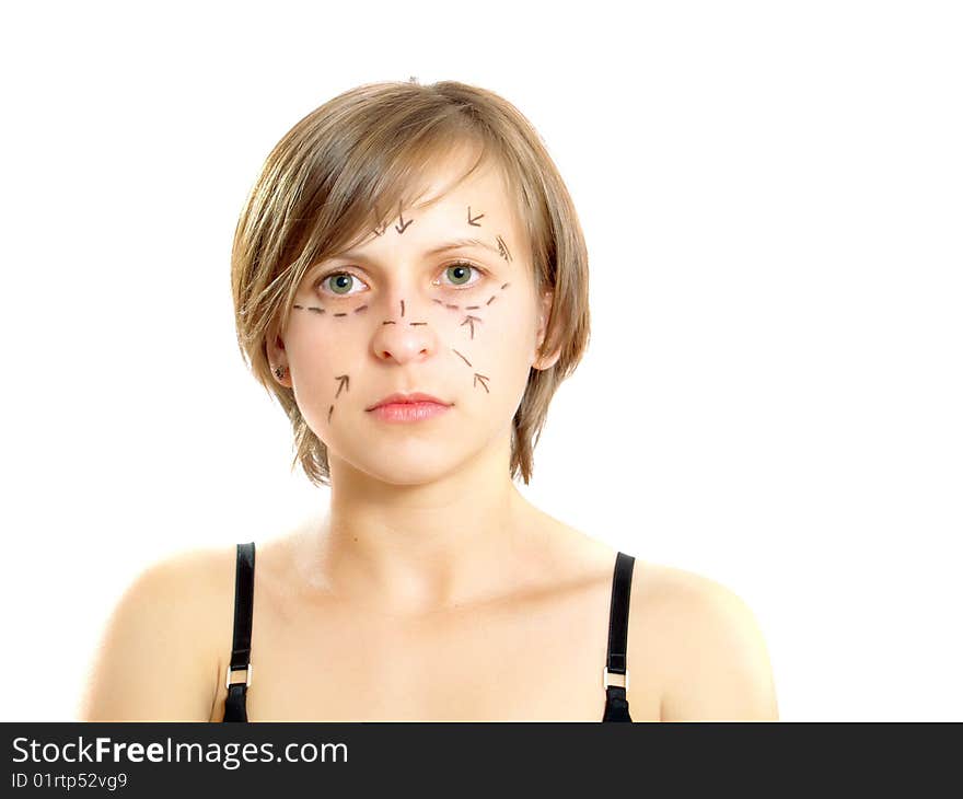 Closeup portrait of an attractive Caucasian girl whose face is marked with lines and arrows for facial cosmetic surgery. Isolated on white. Closeup portrait of an attractive Caucasian girl whose face is marked with lines and arrows for facial cosmetic surgery. Isolated on white.