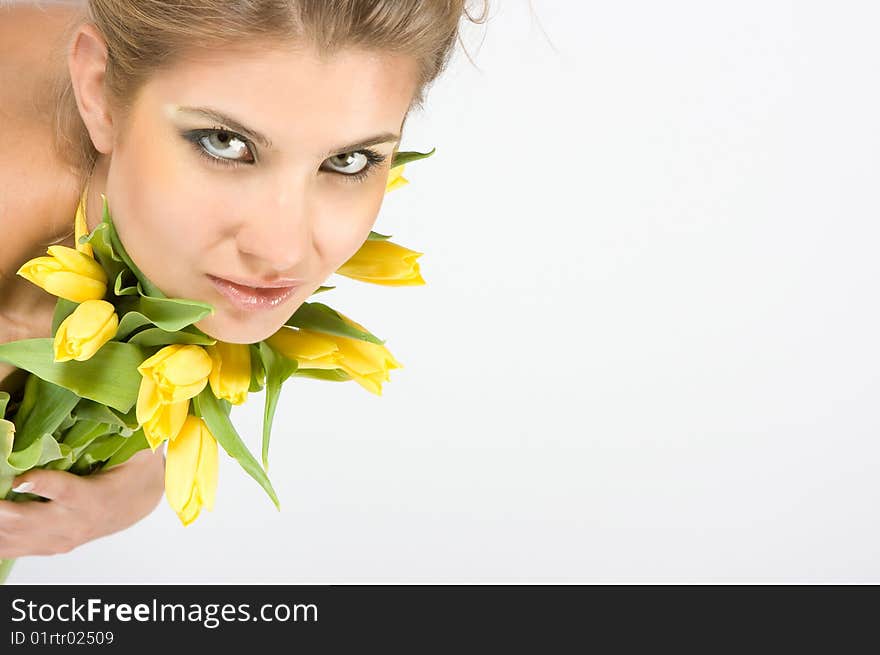 Close-up fresh blonde lady with beautiful make-up with tulips. Close-up fresh blonde lady with beautiful make-up with tulips