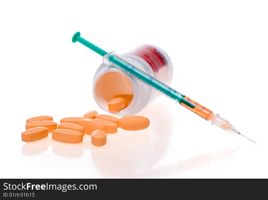 Syringe with a medicine and tablets. Syringe with a medicine and tablets