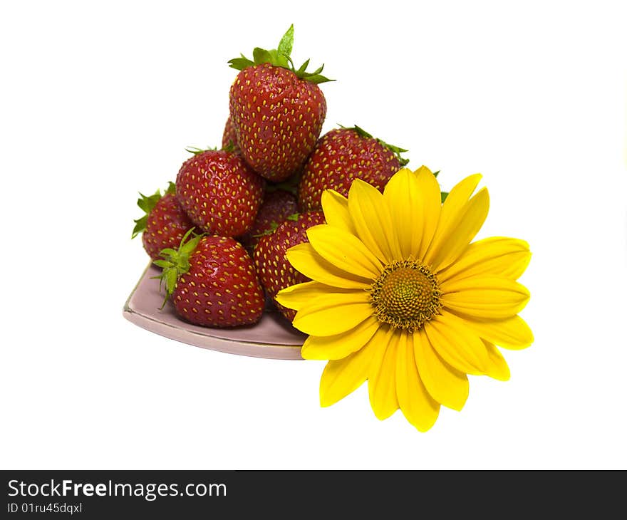 Strawberries and yellow flower on the plate. Strawberries and yellow flower on the plate