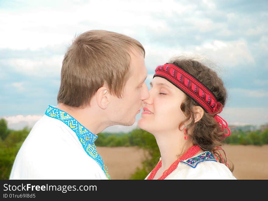 Young boy kissing a girl at sunset. Young boy kissing a girl at sunset