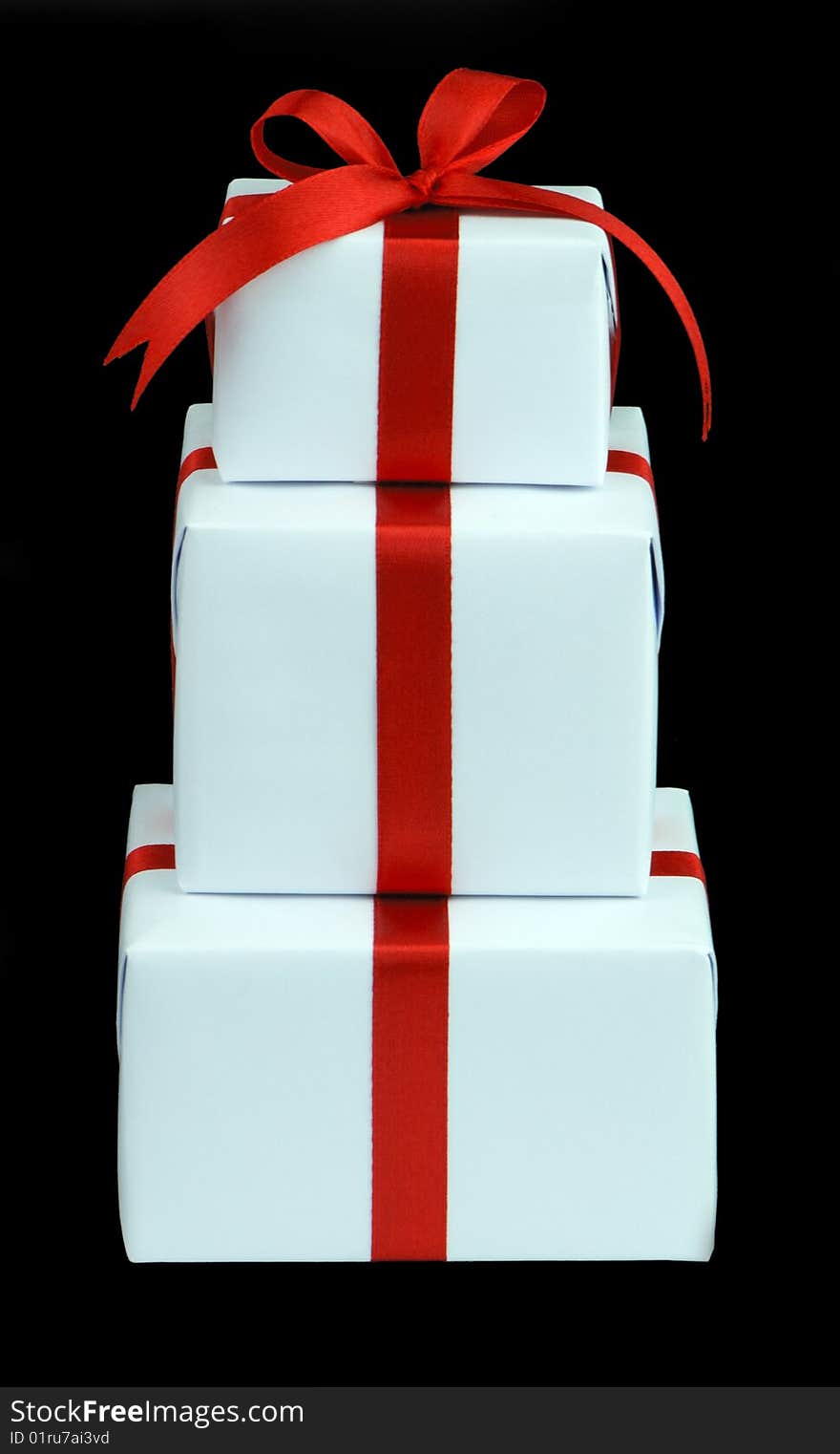 Three white gift boxes with red ribbon