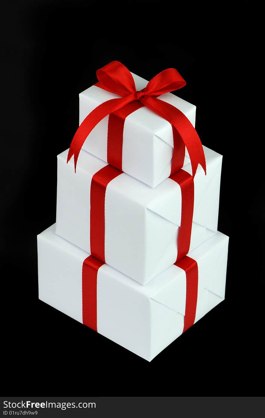 Three White Gift Boxes With Red Ribbon