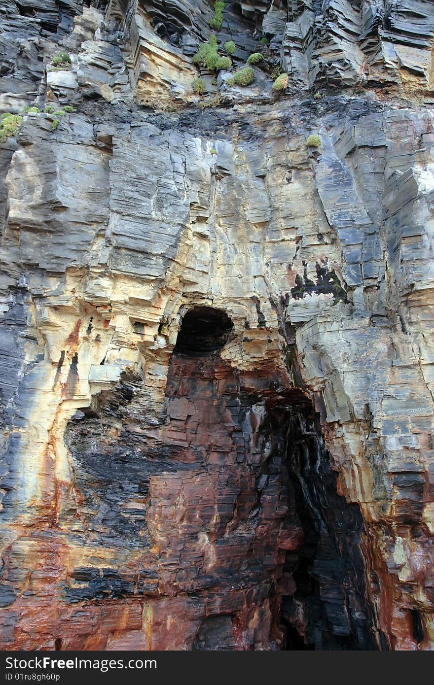 A cave in a cliff face in ireland. A cave in a cliff face in ireland