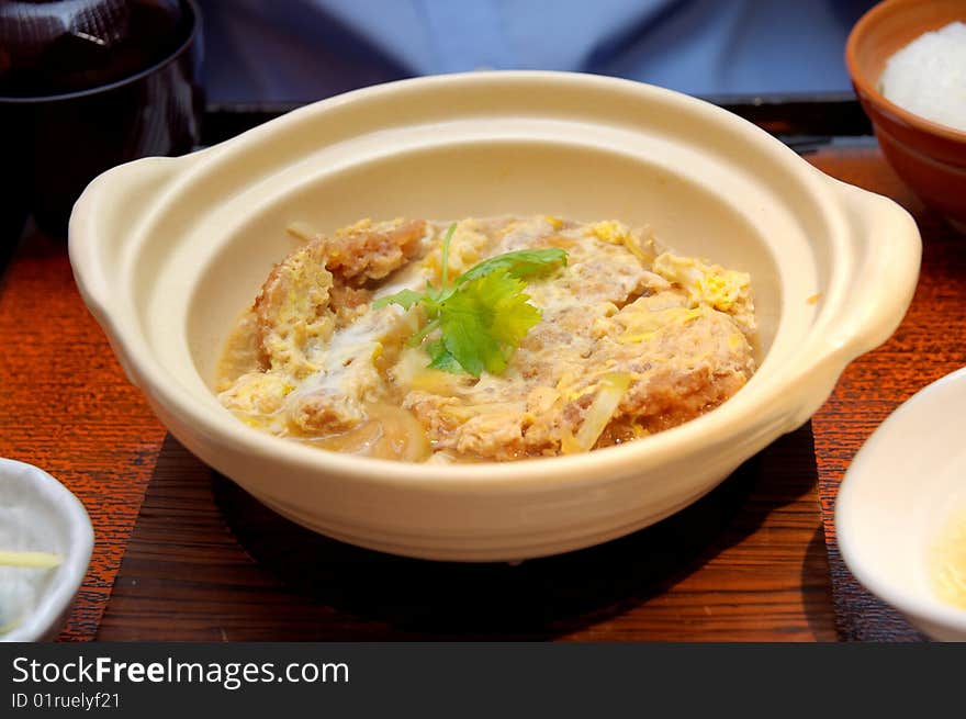 Japanese fried pork chop omelet and rice cooked in claypot