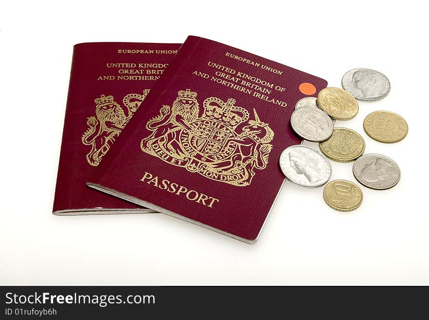 View of two British Passports and a selection of coins. View of two British Passports and a selection of coins