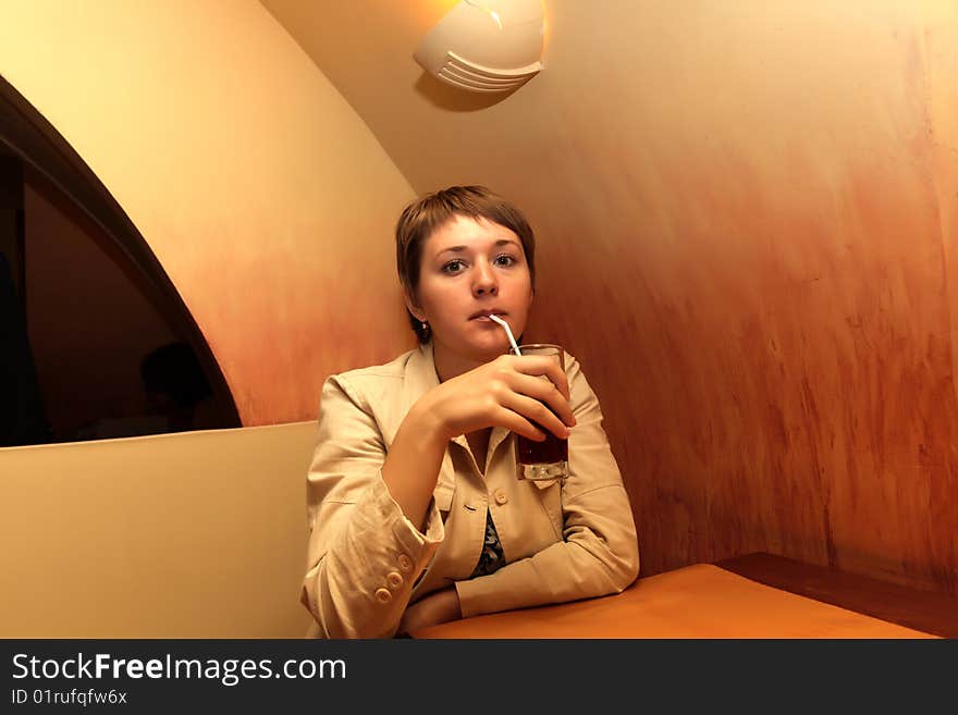 Waiting woman with juice in a cafe